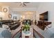 Open concept living room with modern furniture, ceiling fan, and carpet at 1908 Perch Hammock Loop, Groveland, FL 34736