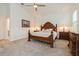 Spacious main bedroom featuring a tray ceiling, ceiling fan, and wood furniture at 1908 Perch Hammock Loop, Groveland, FL 34736