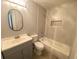 Well-lit bathroom with updated vanity, tub and shower, and light gray tile at 1932 Lake Atriums Cir # 77, Orlando, FL 32839