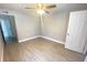 Bright bedroom with wood-look tile flooring and a ceiling fan at 1932 Lake Atriums Cir # 77, Orlando, FL 32839