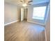 Bright bedroom featuring tile floors, a large window, and a ceiling fan at 1932 Lake Atriums Cir # 77, Orlando, FL 32839