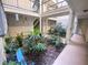 Tranquil courtyard with lush tropical plants, creating a serene and inviting atmosphere at 1932 Lake Atriums Cir # 77, Orlando, FL 32839