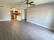 Open-concept living room with neutral walls leading into the kitchen at 1932 Lake Atriums Cir # 77, Orlando, FL 32839