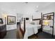 Well-lit bedroom with hardwood floors, four-poster bed, and decoratively styled with a view to ensuite bathroom at 2010 Hoffner Ave, Belle Isle, FL 32809