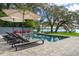 Luxury backyard with pool, lounge chairs, lush landscaping, and waterfront views at 2010 Hoffner Ave, Belle Isle, FL 32809