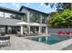 Exterior view of a modern home featuring an in-ground pool and outdoor lounging at 2010 Hoffner Ave, Belle Isle, FL 32809