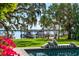 A waterfront view showcases a private dock, inviting chaise lounge, and lush green lawn at 2010 Hoffner Ave, Belle Isle, FL 32809