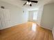 Spacious bedroom with hardwood floors, ceiling fan, window and ensuite bathroom at 2013 Tizewell Cir # 1408, Orlando, FL 32837