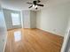 Large bedroom with wood floors, big window, and ensuite bathroom access at 2013 Tizewell Cir # 1408, Orlando, FL 32837