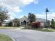 Clubhouse exterior with stone accents, attractive landscaping and a brick driveway at 2013 Tizewell Cir # 1408, Orlando, FL 32837