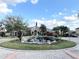 Community entrance with beautiful landscaping, fountain, and an American flag at 2013 Tizewell Cir # 1408, Orlando, FL 32837