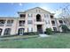 Multi-story condo complex with classic architectural details and vibrant green lawn at 2013 Tizewell Cir # 1408, Orlando, FL 32837