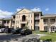 Condo building showcasing its detailed architecture and landscaping under a bright sky at 2013 Tizewell Cir # 1408, Orlando, FL 32837