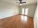 Bright living room with wood floors, a ceiling fan, and glass patio doors at 2013 Tizewell Cir # 1408, Orlando, FL 32837