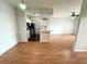 Bright living room featuring wood floors, a ceiling fan, and an open layout into the kitchen at 2013 Tizewell Cir # 1408, Orlando, FL 32837