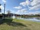 Scenic view of a pond with fountain, surrounded by lush greenery and residential buildings at 2013 Tizewell Cir # 1408, Orlando, FL 32837