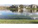 Community pond with a fountain, ducks swimming, and lush green grass at 2013 Tizewell Cir # 1408, Orlando, FL 32837