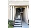 Staircase with neutral walls and landscaping with plants and shrubbery at 2013 Tizewell Cir # 1408, Orlando, FL 32837