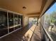 Screened balcony with wood look floors, metal railing and sliding glass doors at 2511 Metro Sevilla Dr # 101, Orlando, FL 32835