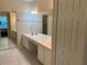 Bathroom featuring a double vanity, large mirror, tile flooring, and a walk-in shower at 2511 Metro Sevilla Dr # 101, Orlando, FL 32835