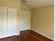 Bedroom featuring hardwood floors and double closets for ample storage space at 2511 Metro Sevilla Dr # 101, Orlando, FL 32835