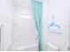 Bright bathroom boasts a tub-shower combo with a stylish whale-themed shower curtain and modern fixtures at 2560 Shanti Dr, Kissimmee, FL 34746