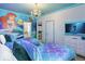 Enchanting bedroom with twin beds, Ariel mural, and soft lighting for a whimsical under-the-sea theme at 2560 Shanti Dr, Kissimmee, FL 34746