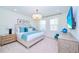 Bright main bedroom with accent pillows, a TV, soft carpet, and modern furnishings at 2560 Shanti Dr, Kissimmee, FL 34746