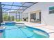 Inviting screened-in pool and spa with a covered patio, perfect for outdoor relaxation and entertainment at 2560 Shanti Dr, Kissimmee, FL 34746