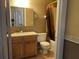 Bathroom with wood vanity with mirror, sink, toilet, and shower with curtain at 26 Palm Run, Ocala, FL 34472