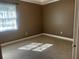 Brown painted bedroom featuring a window with natural light at 26 Palm Run, Ocala, FL 34472