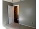 Neutrally painted bedroom with doorway leading to ensuite bath at 26 Palm Run, Ocala, FL 34472