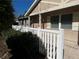 Charming front exterior with a white picket fence, light-colored stucco, and inviting front porch at 26 Palm Run, Ocala, FL 34472