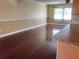 Bright living room showcases hardwood floors and decorative molding; a window offers natural light at 26 Palm Run, Ocala, FL 34472