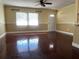 Inviting living room with hardwood floors, neutral paint, and a large window for ample sunlight at 26 Palm Run, Ocala, FL 34472