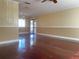 Spacious living room with elegant hardwood floors, decorative trim, and plenty of natural light at 26 Palm Run, Ocala, FL 34472