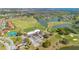 Community aerial shot showcasing a golf course, water features, tennis courts and many homes at 2806 Baywood Ln, Kissimmee, FL 34746