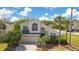 Two-story home with a 2-car garage, palm trees, and mature landscaping on a sunny day at 2806 Baywood Ln, Kissimmee, FL 34746