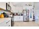 Stylish kitchen featuring white cabinets, stainless appliances, and wood-look tile flooring at 2806 Baywood Ln, Kissimmee, FL 34746