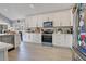 Modern kitchen features white cabinets, stainless steel appliances, and light tile flooring at 2806 Baywood Ln, Kissimmee, FL 34746