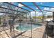 Backyard pool featuring a safety fence, waterfall features, and a brick pool deck at 2806 Baywood Ln, Kissimmee, FL 34746