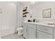 Bright bathroom featuring white cabinets, modern fixtures, and decorative shelves at 3245 Upland Pt, Oviedo, FL 32765