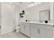 Stylish bathroom with dual sinks, white cabinets, and modern decor at 3245 Upland Pt, Oviedo, FL 32765