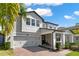 Charming two-story home with a two car garage, brick driveway, and lush landscaping at 3245 Upland Pt, Oviedo, FL 32765