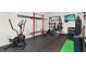 Home gym featuring an elliptical, weight rack, punching bag, and television at 3245 Upland Pt, Oviedo, FL 32765