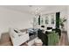 Bright living room featuring hardwood floors, modern lighting, and stylish green and white furniture at 3245 Upland Pt, Oviedo, FL 32765