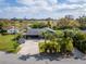 Aerial view of a charming blue home surrounded by lush greenery and mature trees at 328 Lake Fair Ln, Winter Park, FL 32789