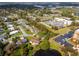 Residential neighborhood aerial view with mature trees, lawns, and nearby parking and commercial buildings at 328 Lake Fair Ln, Winter Park, FL 32789