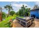 Relaxing backyard deck with outdoor furniture and a view of the lush lawn at 328 Lake Fair Ln, Winter Park, FL 32789