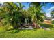 Secluded backyard hammock area surrounded by lush tropical landscaping and peaceful ambiance at 328 Lake Fair Ln, Winter Park, FL 32789